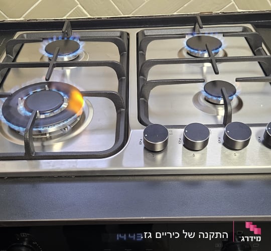 כיריים גז עם להבות כחולות במטבח מודרני